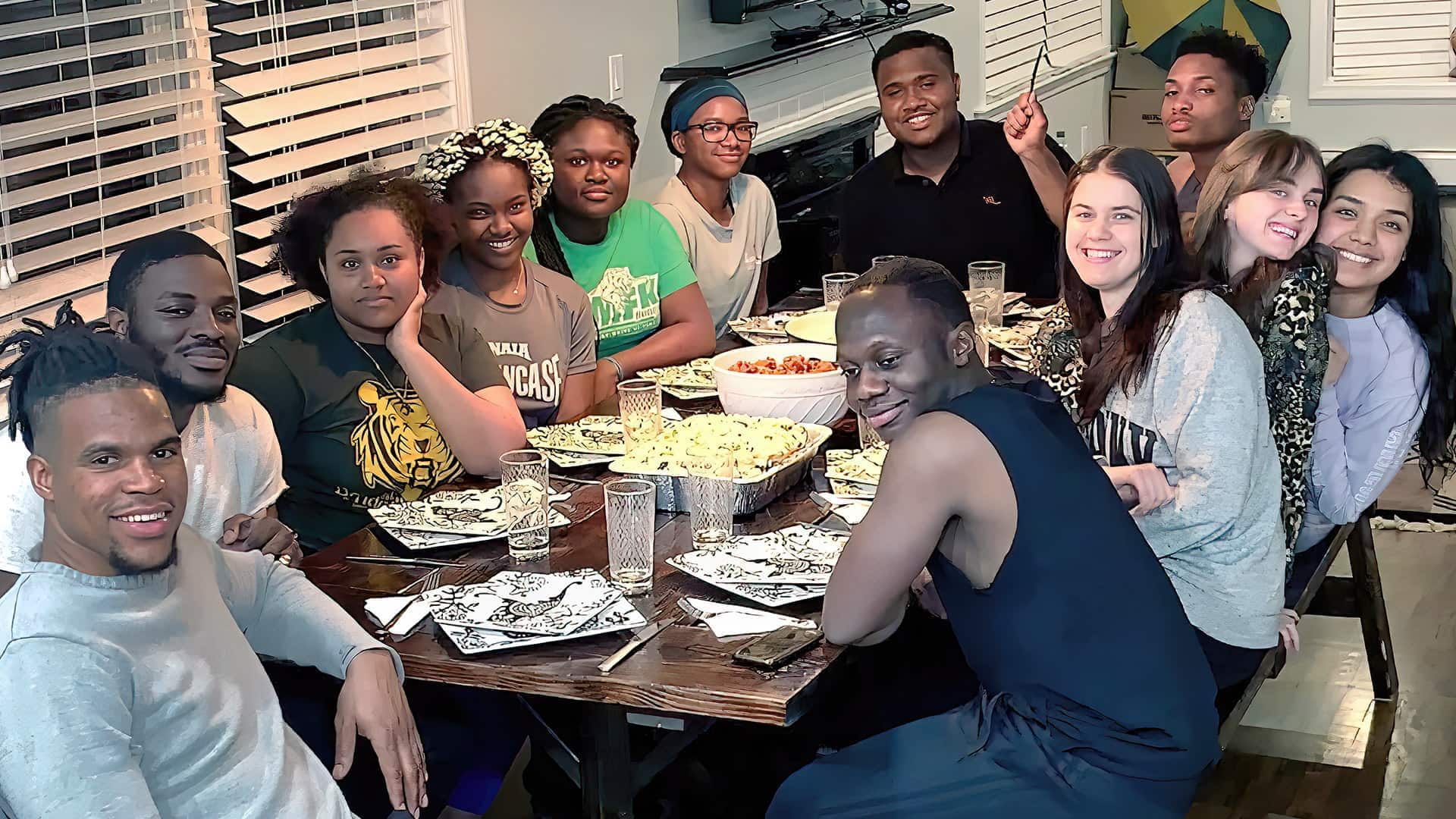 International students enjoying a meal together around a table